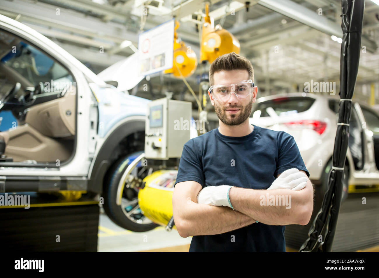 Portrait of confident worker in modern car factory Stock Photo