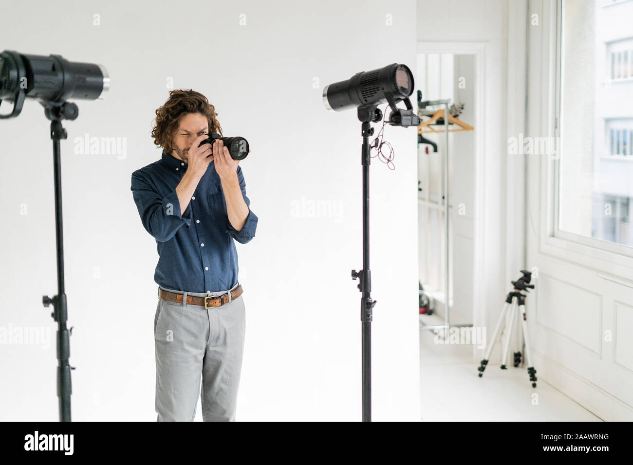 Photographer taking pictures in his studio Stock Photo