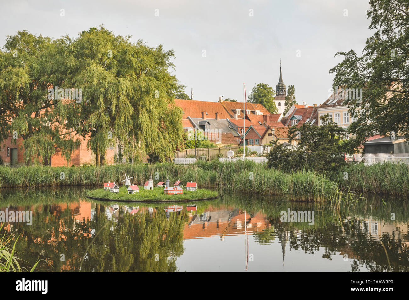 Denmark, Aeroe, Aeroskobing, House figurines on pond seen over water Stock Photo