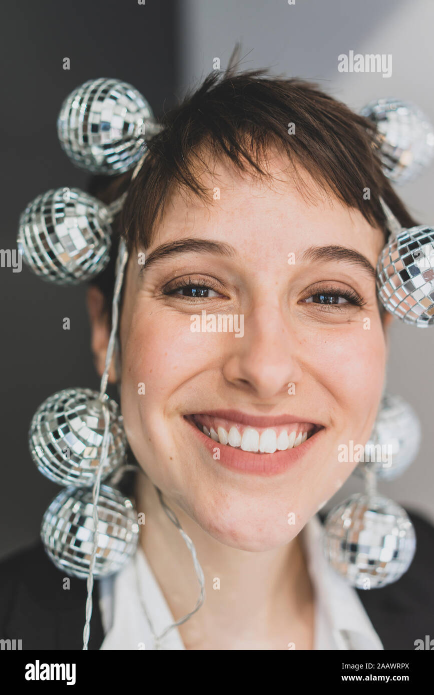 Portait of happy young businesswoman  wearing mirror balls Stock Photo