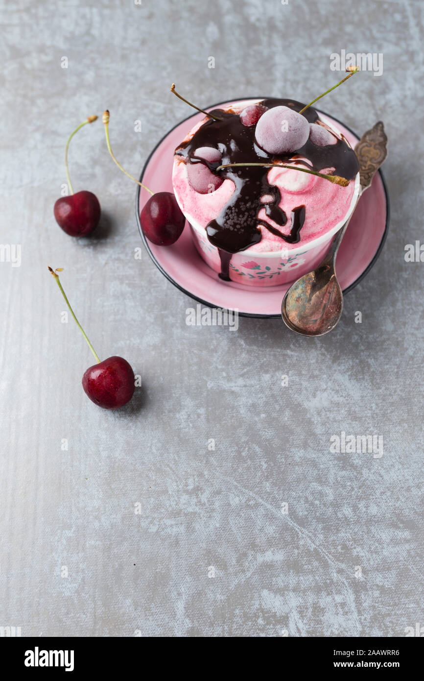 High angle view of cherry ice cream with chocolate sauce served on table Stock Photo