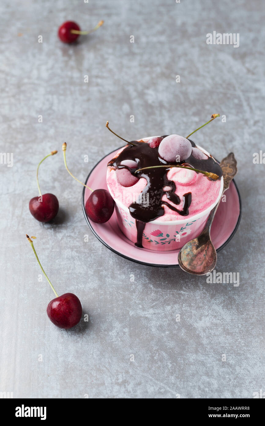 High angle view of cherry ice cream with chocolate sauce served in bowl on table Stock Photo