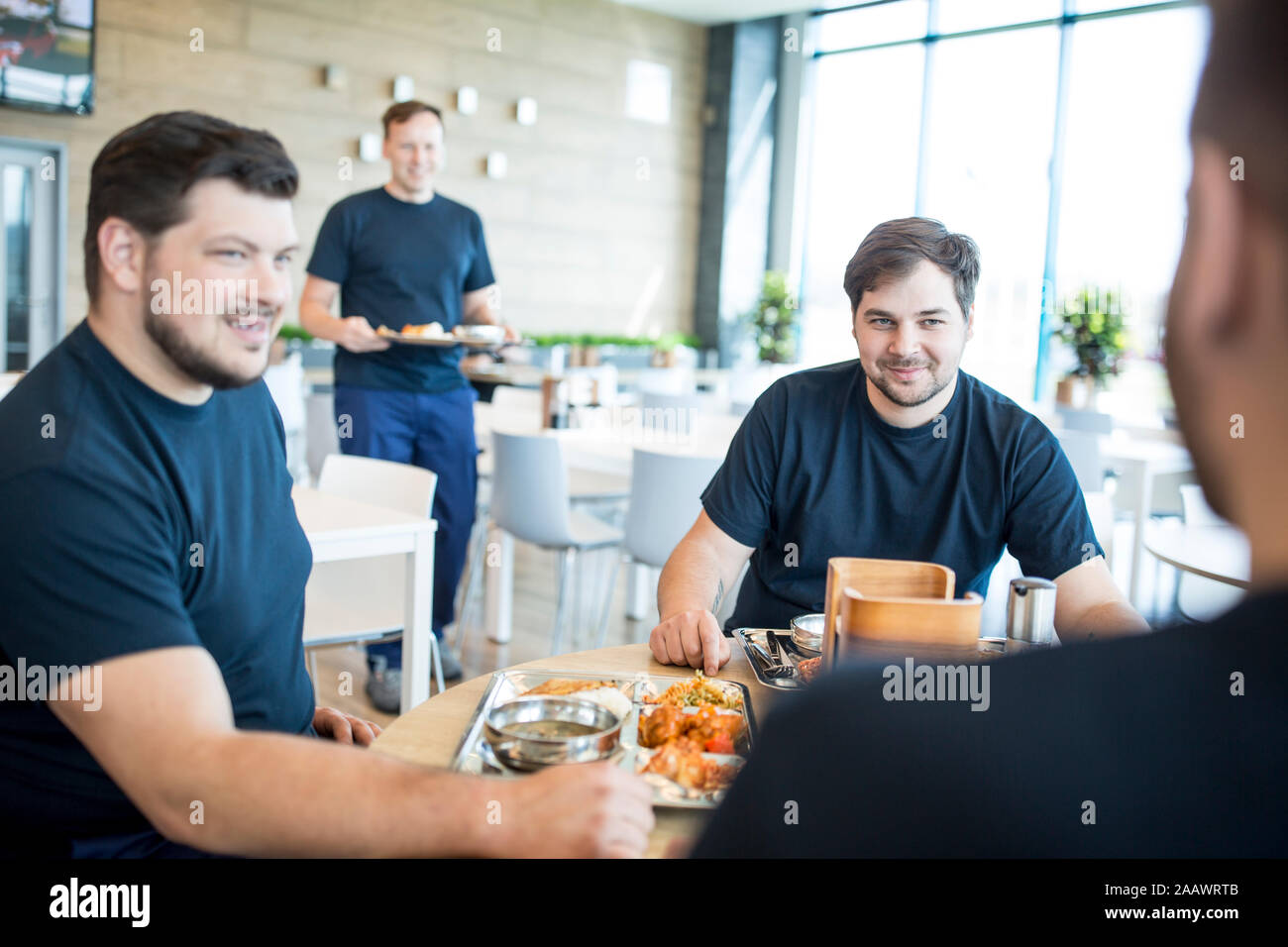 Colleagues having lunch break in canteen Stock Photo
