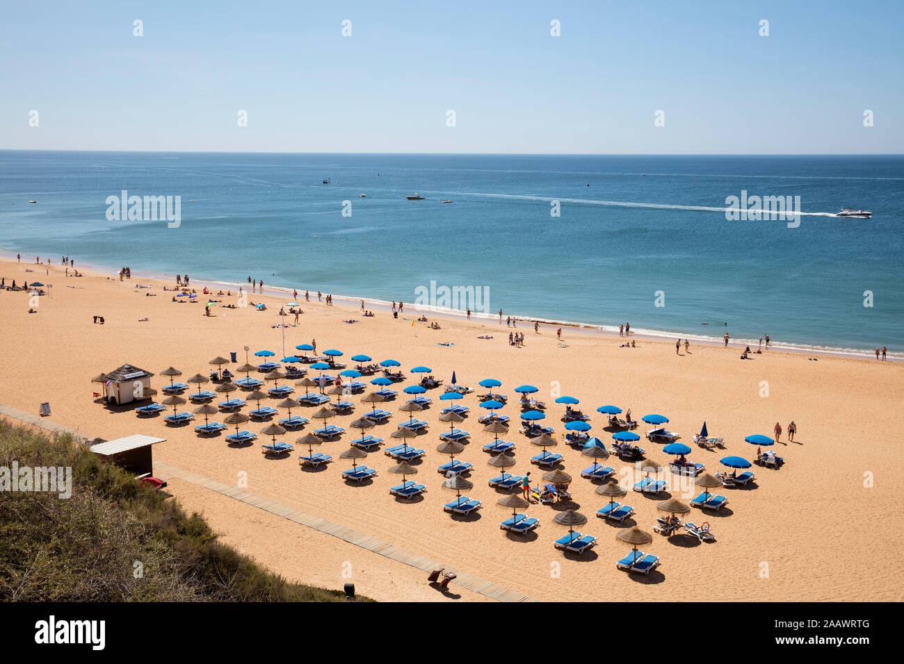 Sunbeds and parasols at beach during summer, Albufeira, Algarve, Portugal Stock Photo