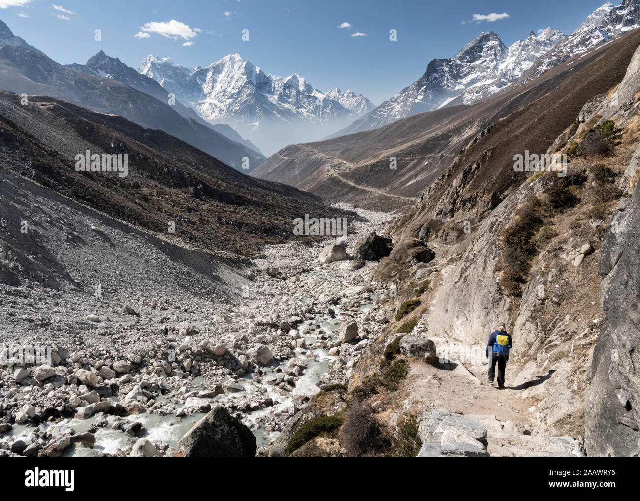 Woman trekking in the Himalayas, Nepal Stock Photo