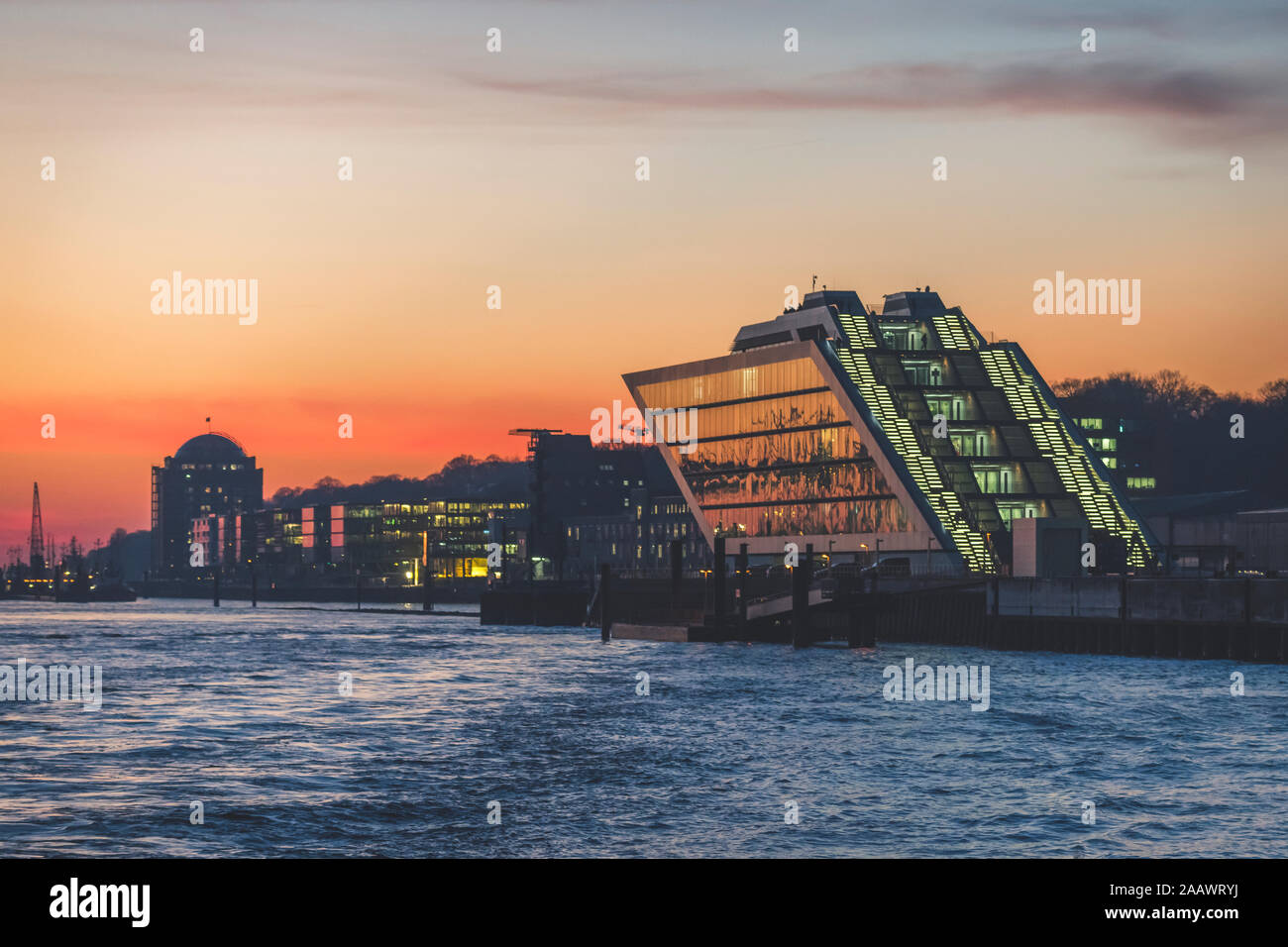 View of Dockland building by Elbe River against sky during sunset, Hamburg, Germany Stock Photo