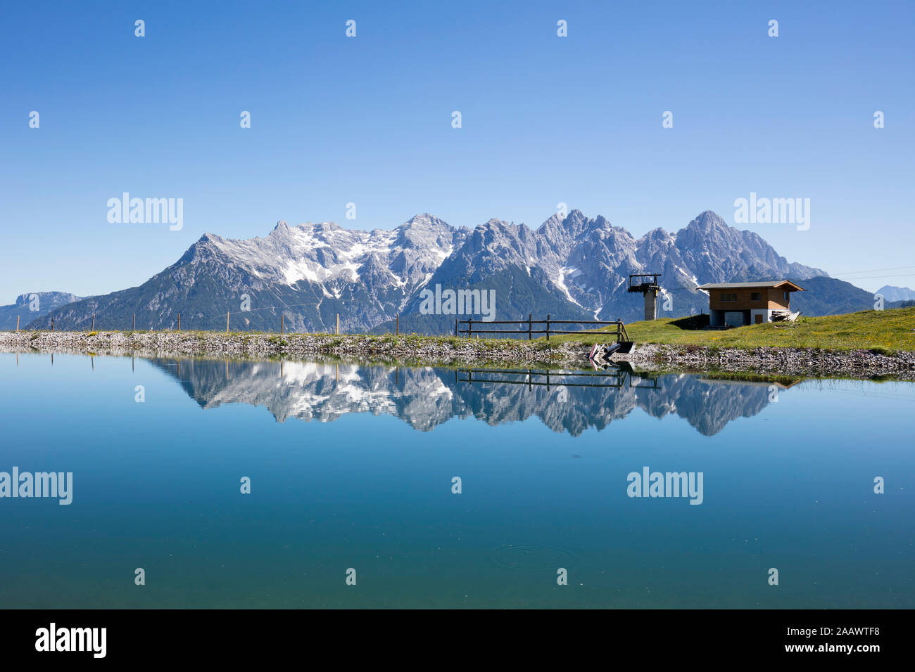 Scenic view of calm lake and Loferer Steinberge against clear blue sky, Kitzbühel, Tyrol, Austria Stock Photo