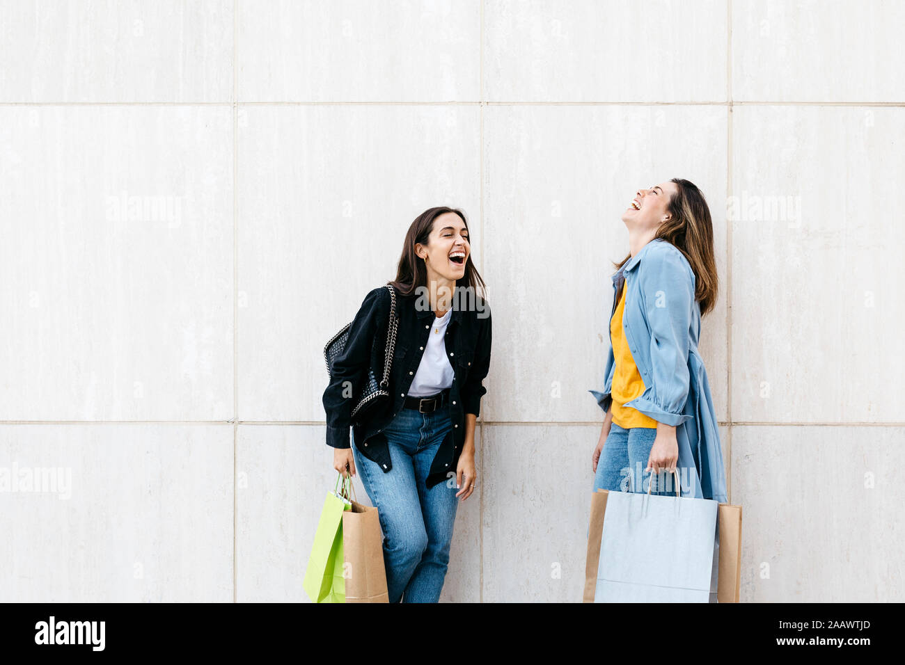 Two friends laughing during shopping Stock Photo