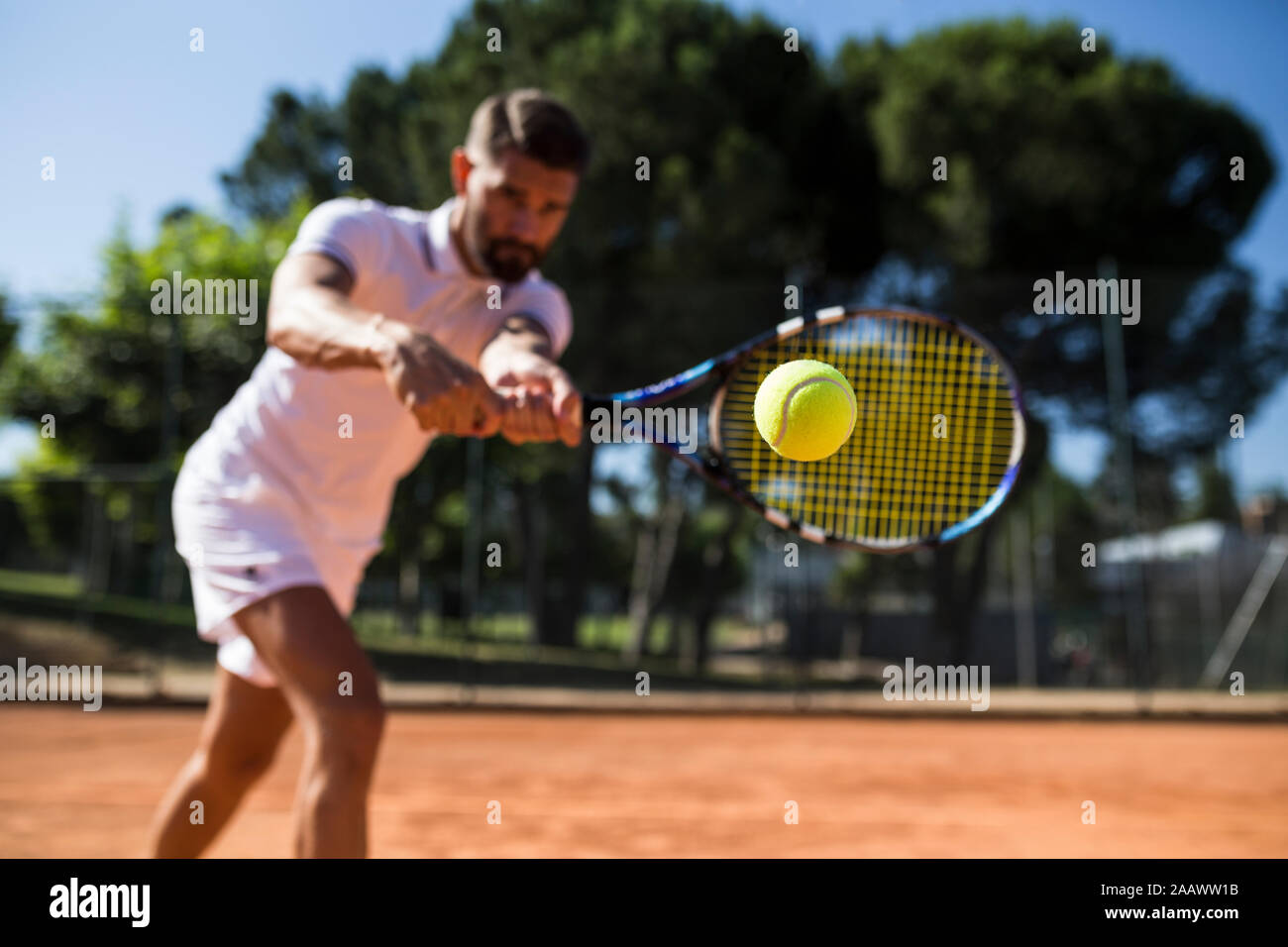 Tennis player during a tennis match, focus on tennis ball Stock Photo