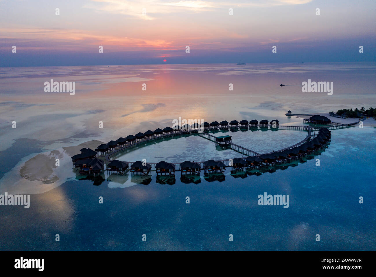 Aerial view of stilt houses at Olhuveli island during sunrise at Maldives Stock Photo