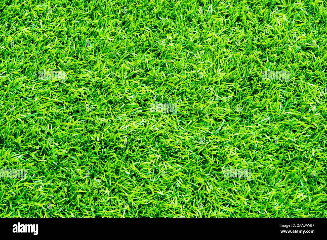 Texture of plastic artificial grass and the rubber pellets on school