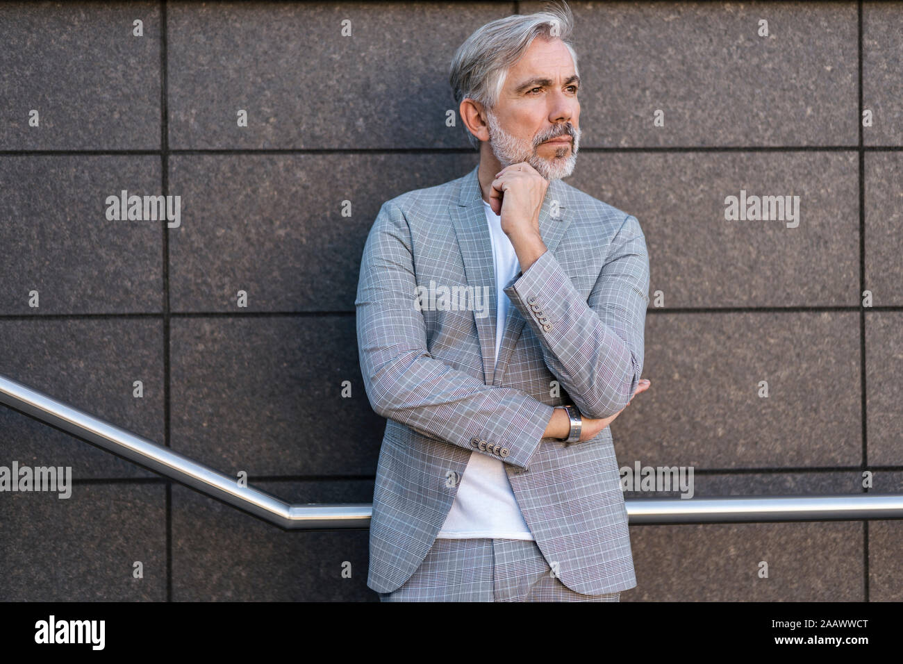Fashionable mature businessman standing outdoors Stock Photo