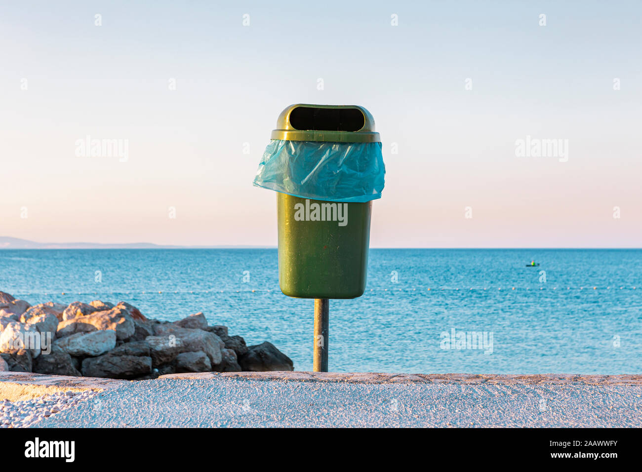 Croatia, Krk, trash bin against tranquil sea Stock Photo