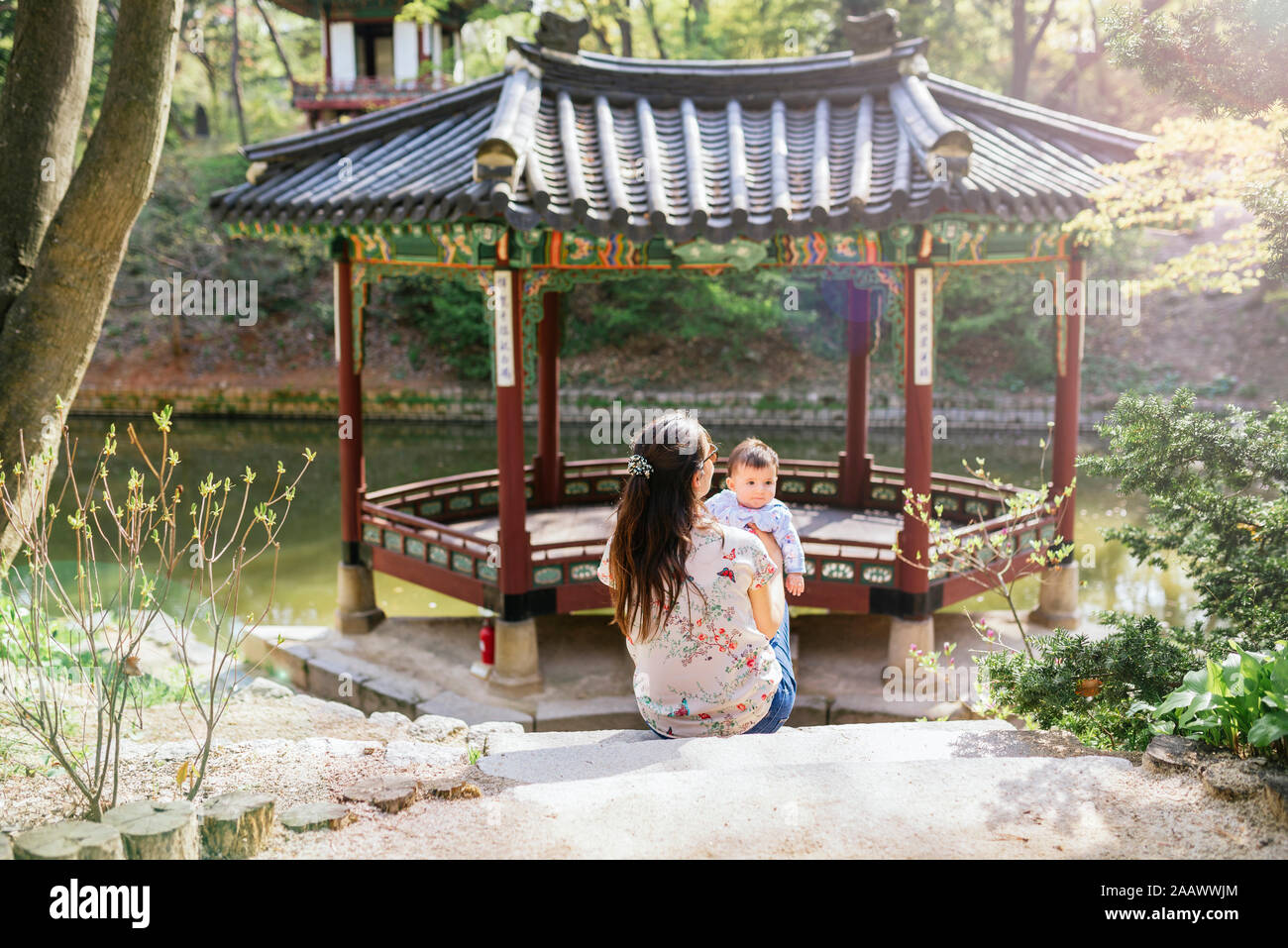 Mother and baby girl visiting pagoda in the Secret Garden, Changdeokgung, Seoul, South Korea Stock Photo