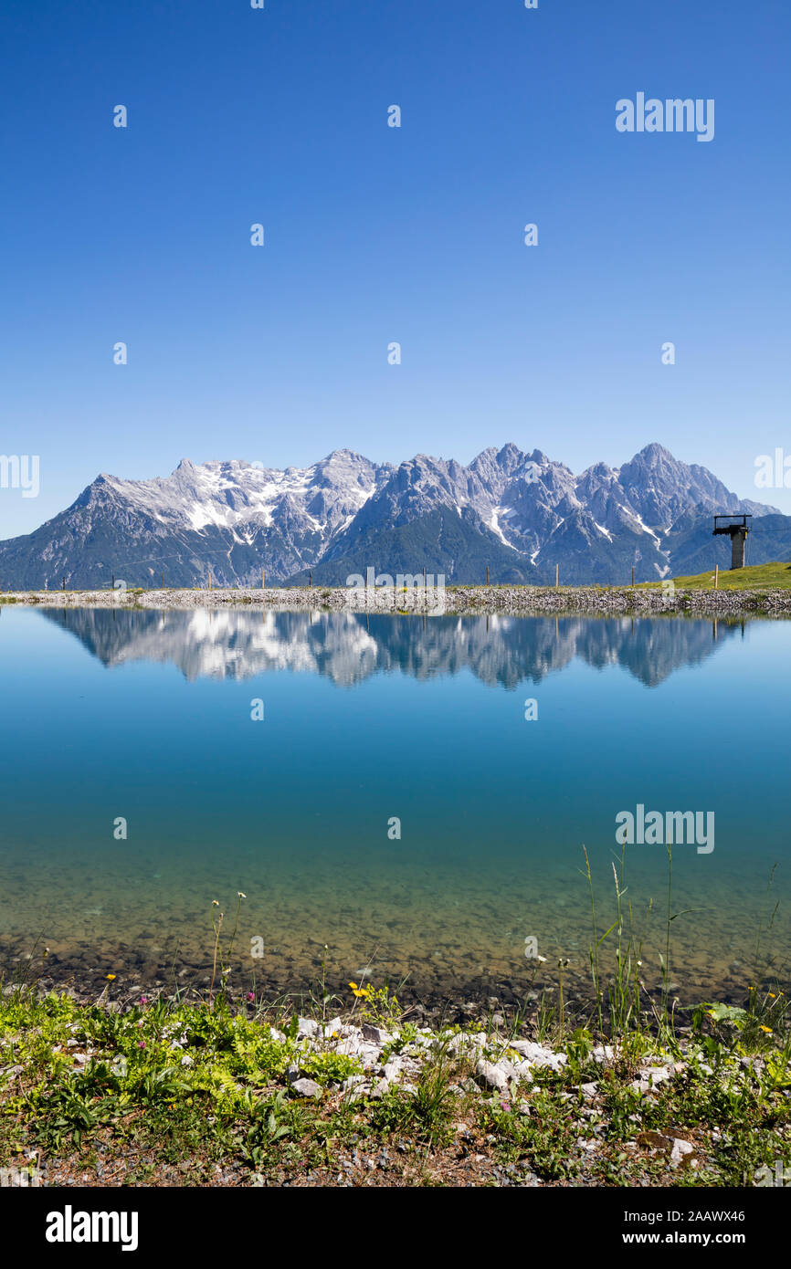 Scenic view of lake and Loferer Steinberge against clear blue sky, Kitzbühel, Tyrol, Austria Stock Photo