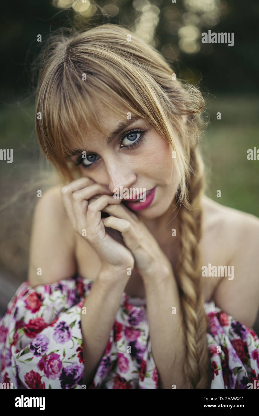 Portrait of young blond woman with braid in summer Stock Photo