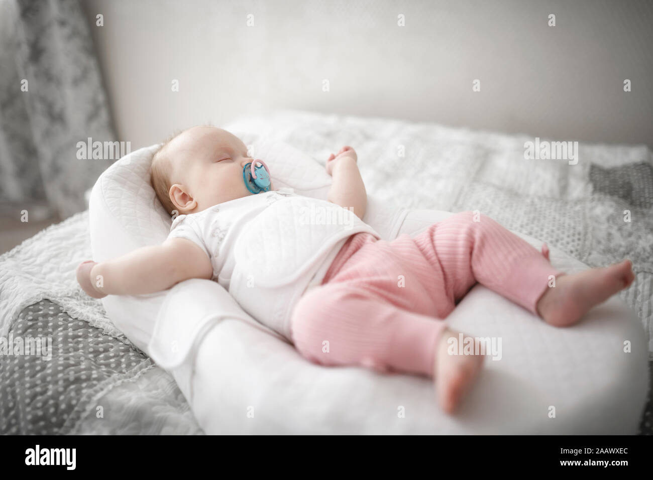 Cute baby girl sleeping on the bed Stock Photo