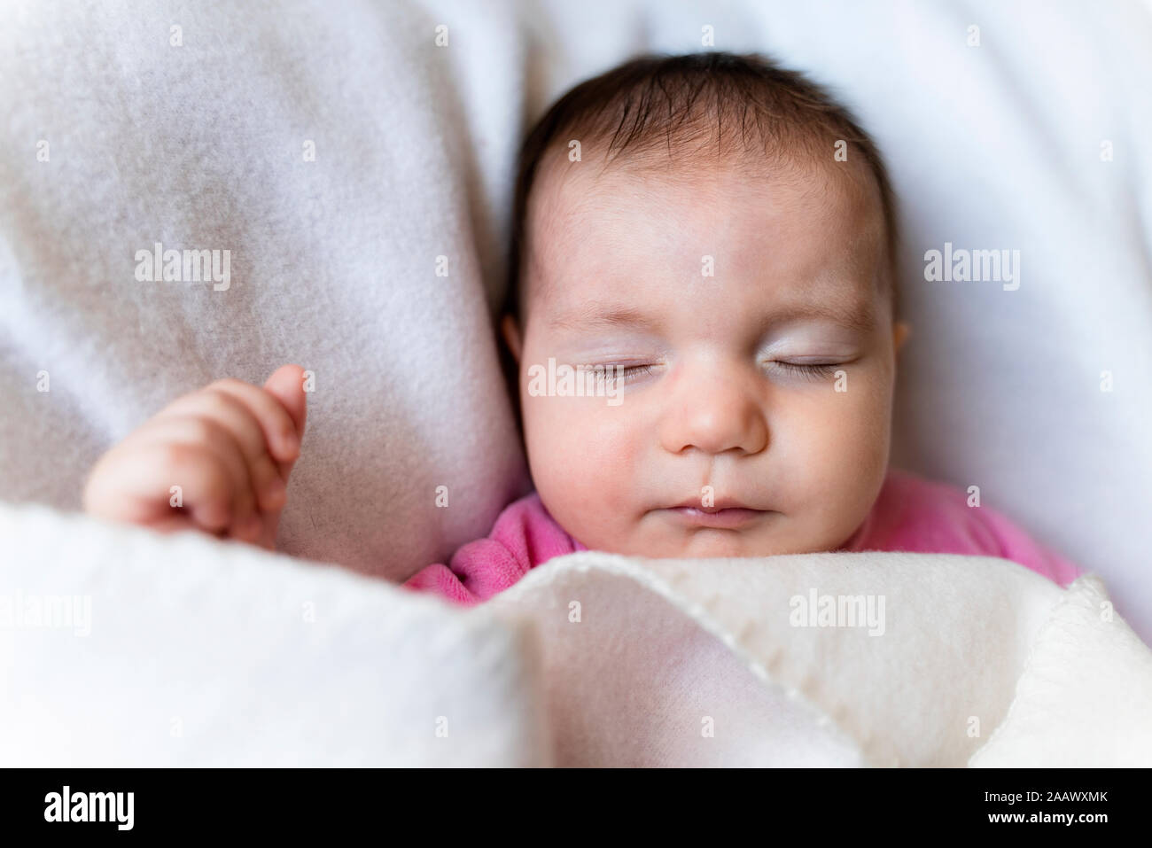 Portrait of sleeping baby girl with cat toy Stock Photo