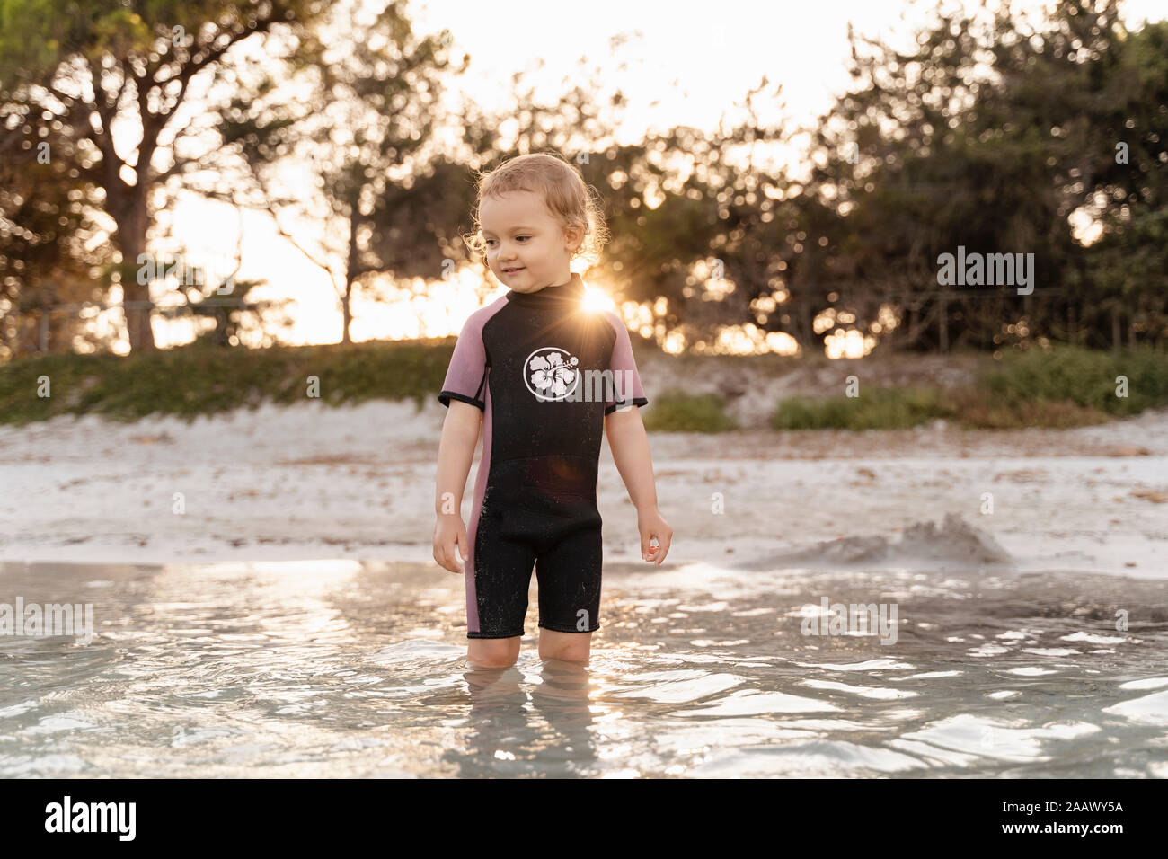 Cute toddler girl standing in the sea Stock Photo