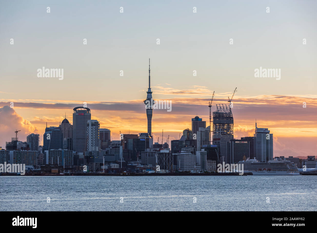 Modern buildings by sea against cloudy sky at sunset, Oceania, New Zealand Stock Photo