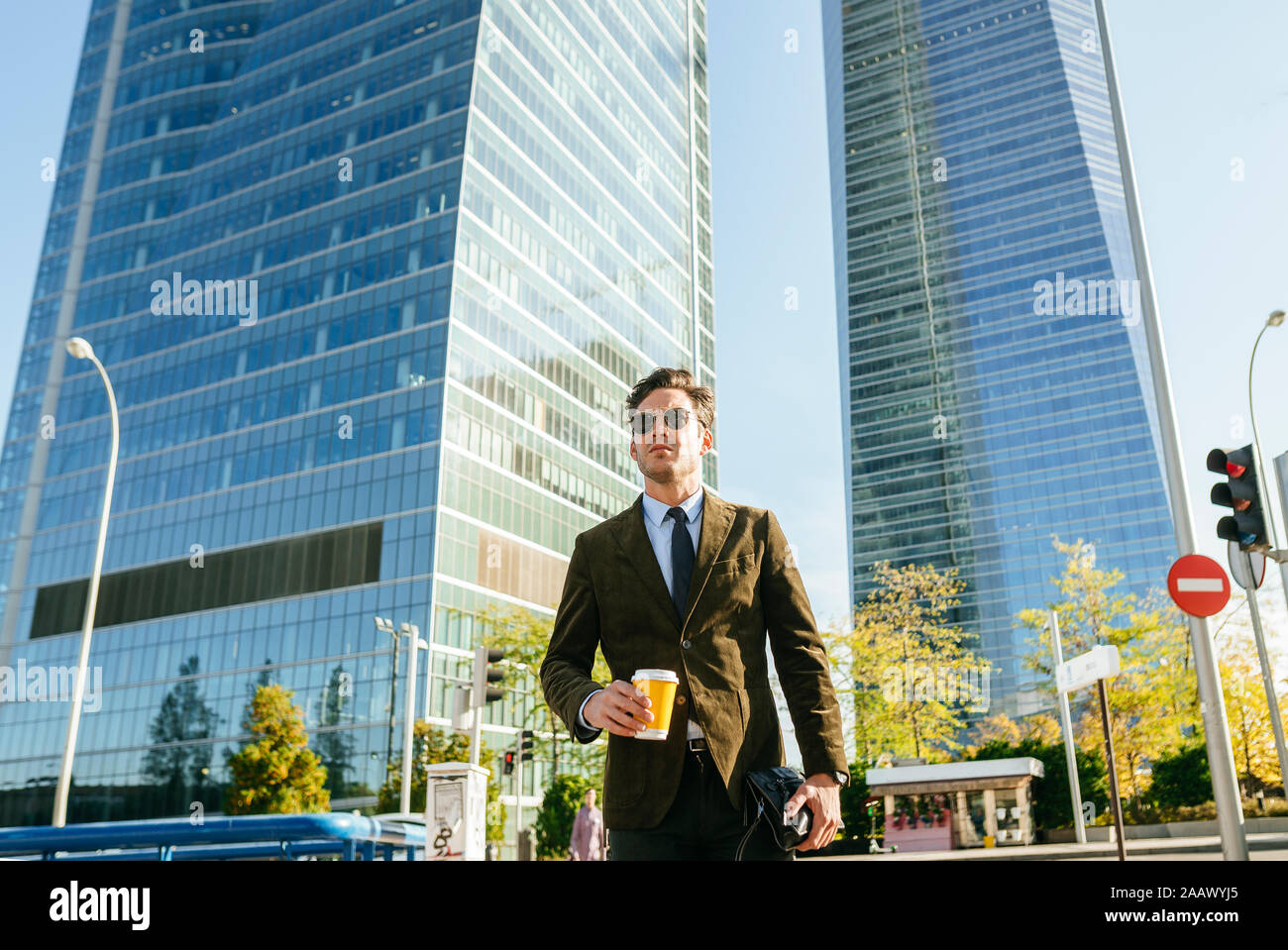 Confident businessman walking in urban business district, Madrid, Spain Stock Photo