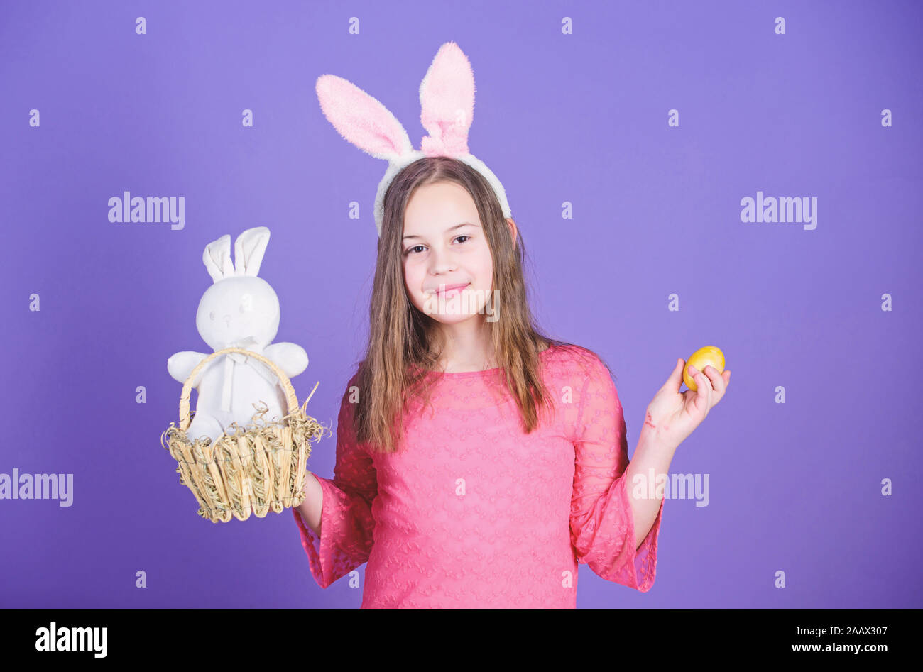 Easter egg hunts as part of festival. Girl little child easter bunny accessory hold dyed egg