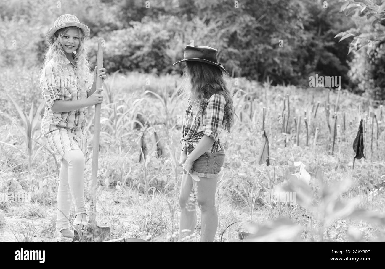 Agriculture concept. Sisters together helping at farm. Girls planting