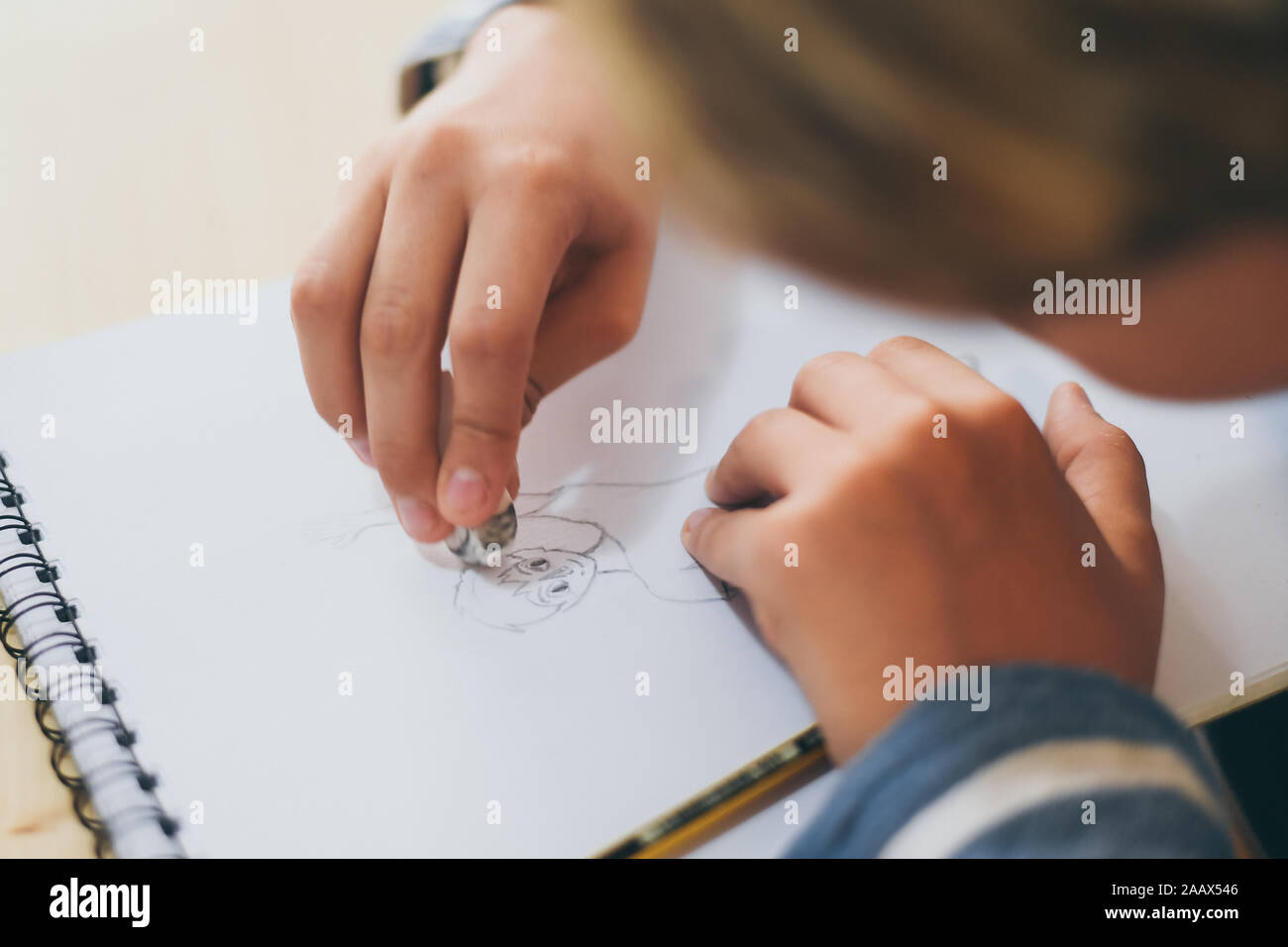 Close up view of student drawing with pencil. Boy doing homework ...