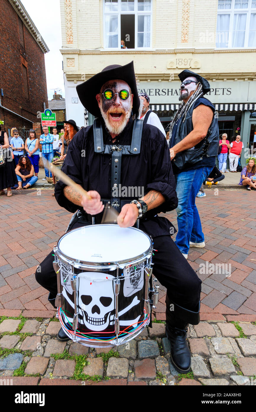 Mature man from the Drumskullz drumming group at the Faversham Hop Festival. In street and dressed in pirates costume and white face make up. Facing. Stock Photo