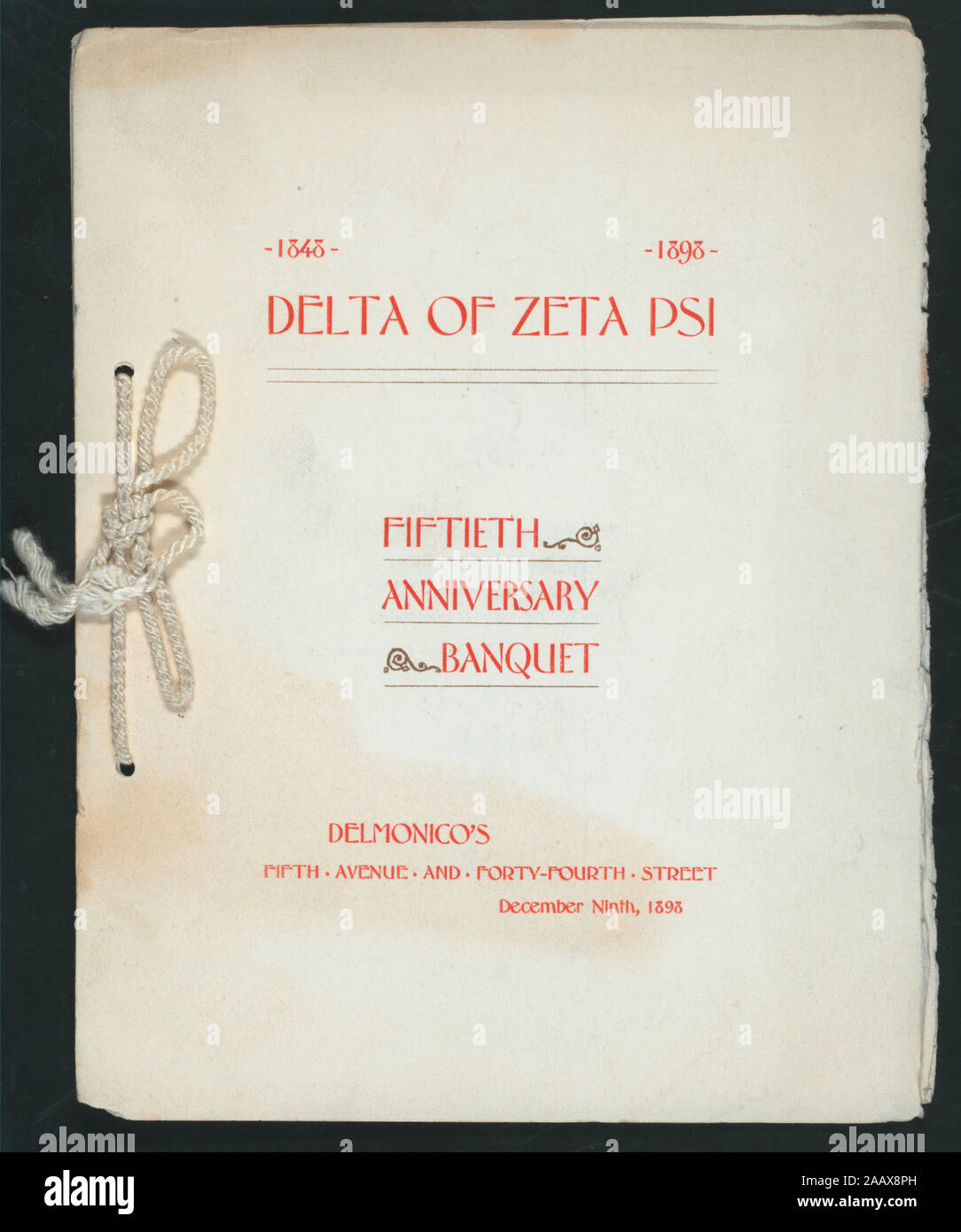 FIFTIETH ANNIVERSARY BANQUET (held by) DELTA OF ZETA PSI (at) DELMONICO,S (NY) (REST;) RED PRINT; WHITE CORD; ILLUS OF A BUILDING ON BACK COVER; TOASTS; FIFTIETH ANNIVERSARY BANQUET [held by] DELTA OF ZETA PSI [at] DELMONICO,S [NY] (REST;) Stock Photo