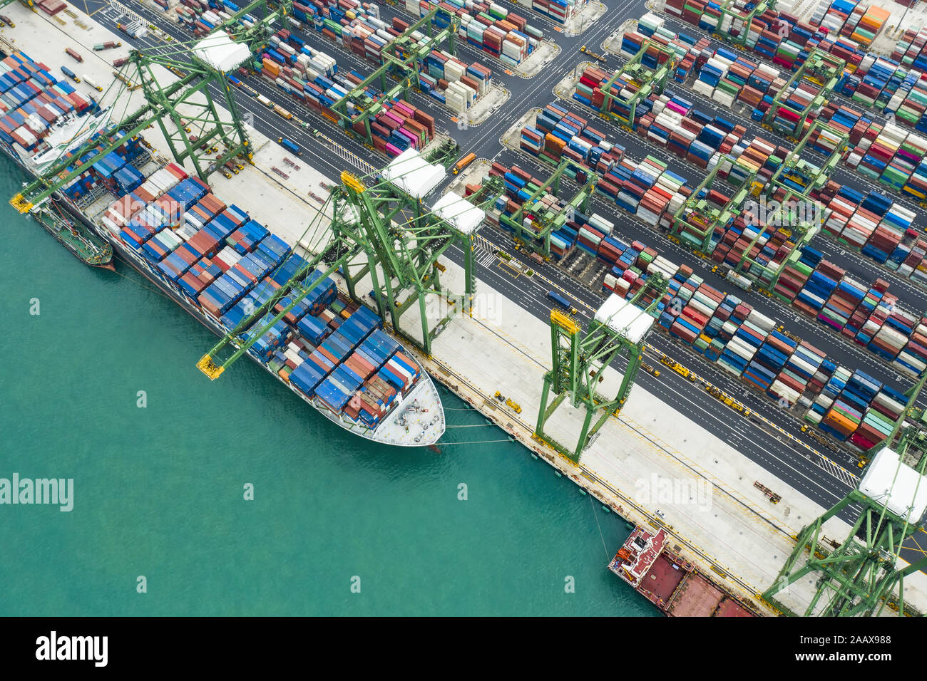 View from above, stunning aerial view of the port of Singapore with hundreds of colored containers ready to be loading on the cargo ships. Stock Photo