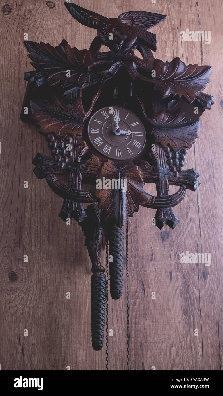Cuckoo clock hanging on a rustic wooden wall Stock Photo Alamy