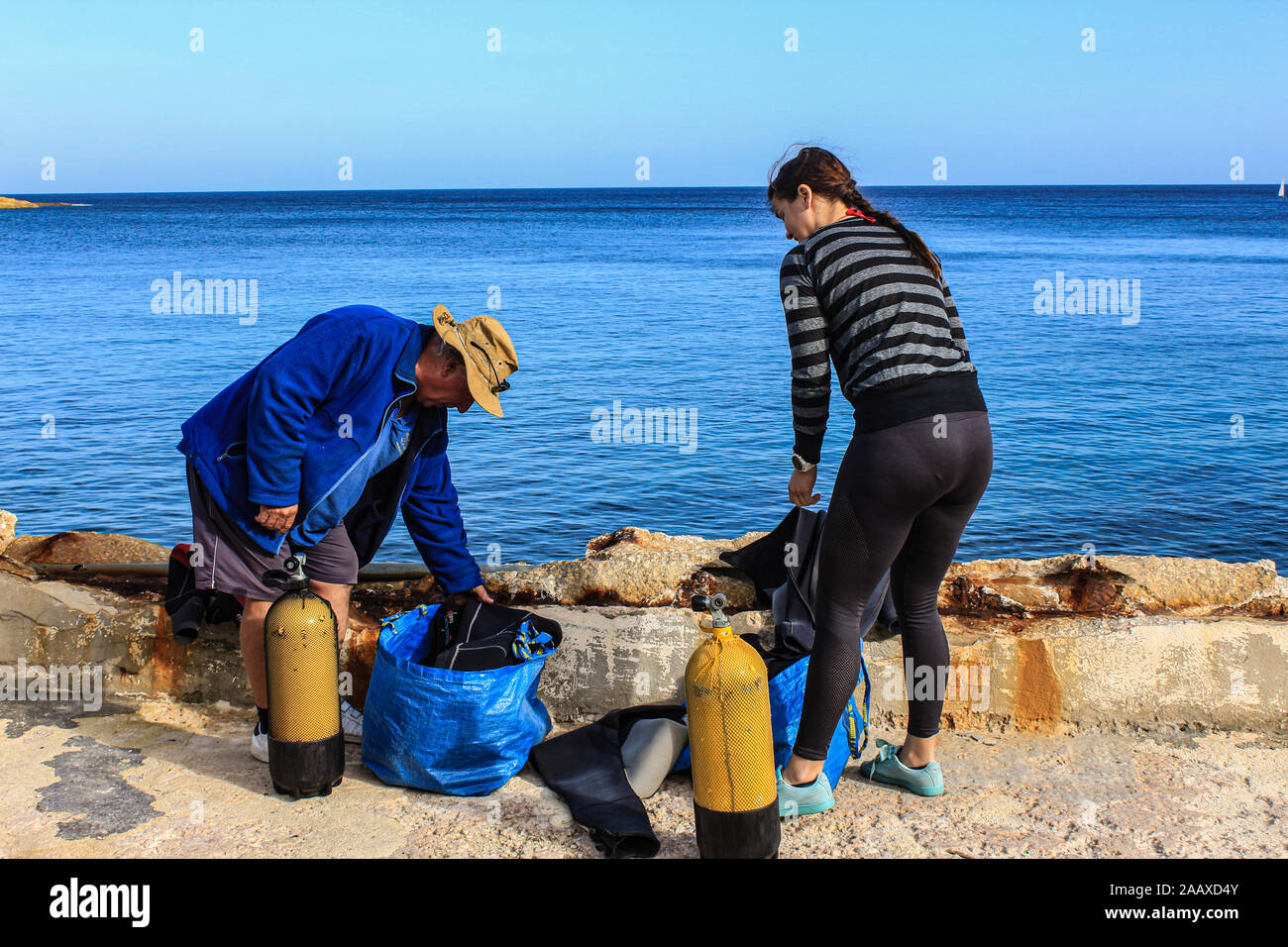Preparing the dive kit at St Elmo's Bay, Malta. Stock Photo