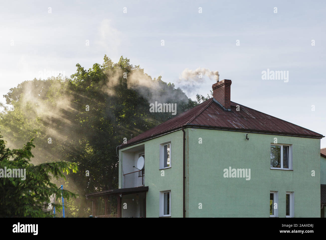 Smoke from chimney polluting air and causing smog Stock Photo