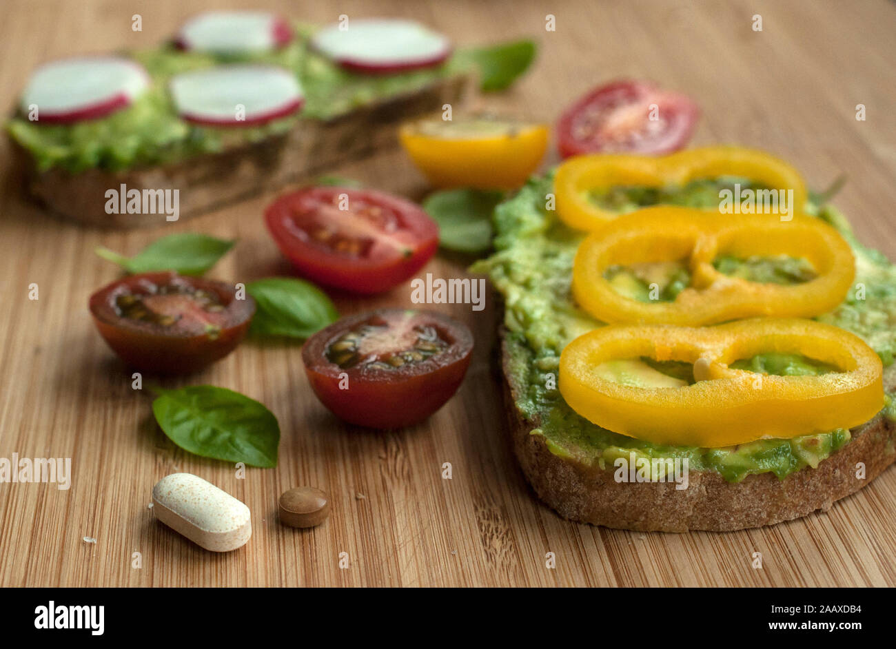 Supplements as part of a natural and balanced diet. Pills and food served together. Future of nutrition. Stock Photo