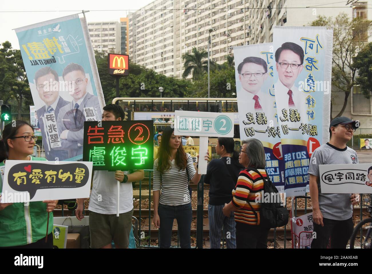Volunteers campaign on a street ahead of District Council Elections.Hong Kong held its district council election under a rare atmosphere of calm and peace after weeks of intense clashes at numerous universities between anti-government protesters and police which continue into its sixth month of demonstrations. Stock Photo
