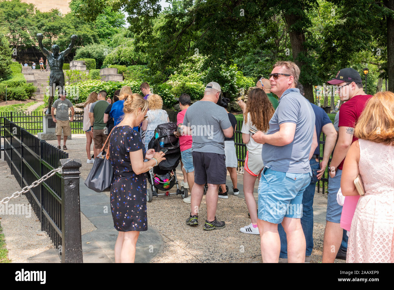 People queuing to have their picture taken at A. Thomas Schomberg's statue of Rocky at the Philadelphia Museum of Art Stock Photo