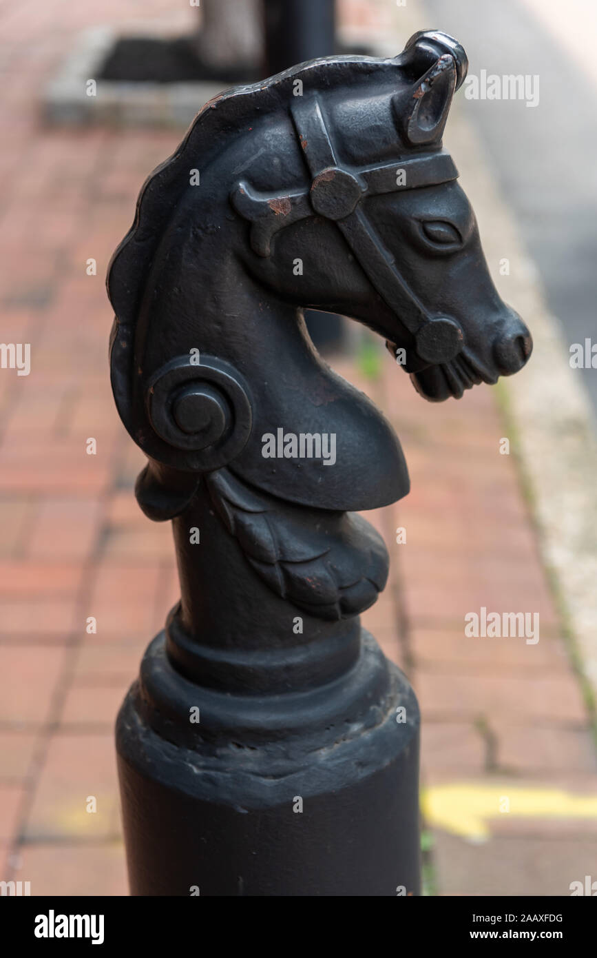 A horse's head atop a traditional iron horse hitching post in one of Philadelphia's historic streets. Stock Photo