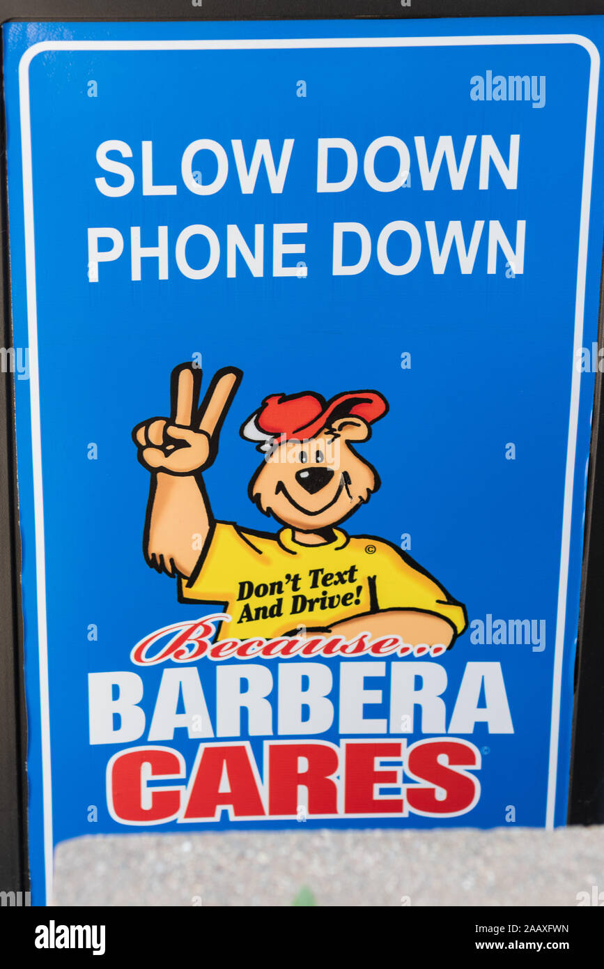 A sign of the times, warning of the dangers of texting while driving, sponsored by Barbera's Autoland, Philadelphia Stock Photo
