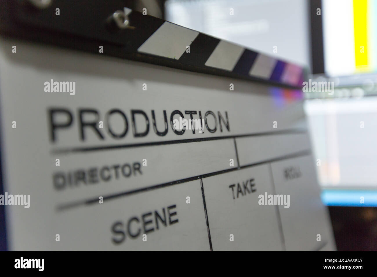 Movie clapper and editing room in background Stock Photo - Alamy