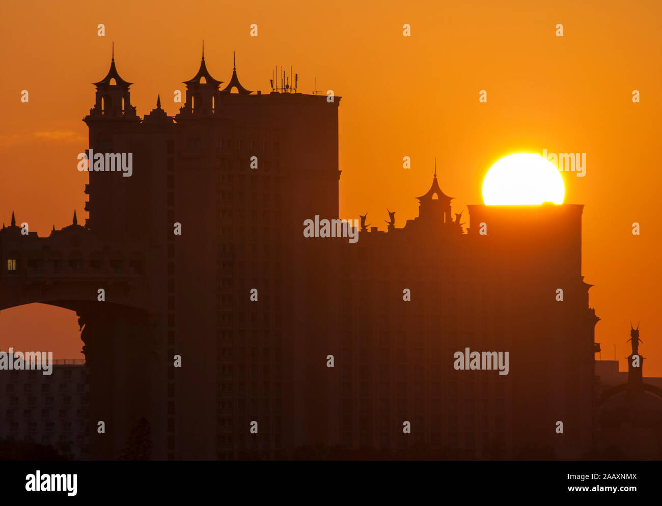 The sun rising from behind the building on Paradise island, popular ...