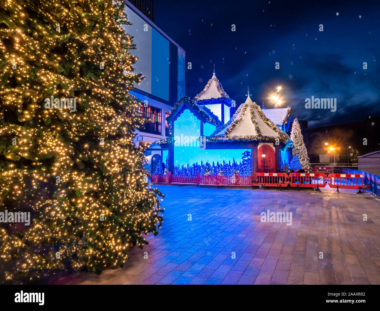 Christmas scene outdoor with decorated tree and ornamental lights in front on the main entrance of Westfield of London Stock Photo