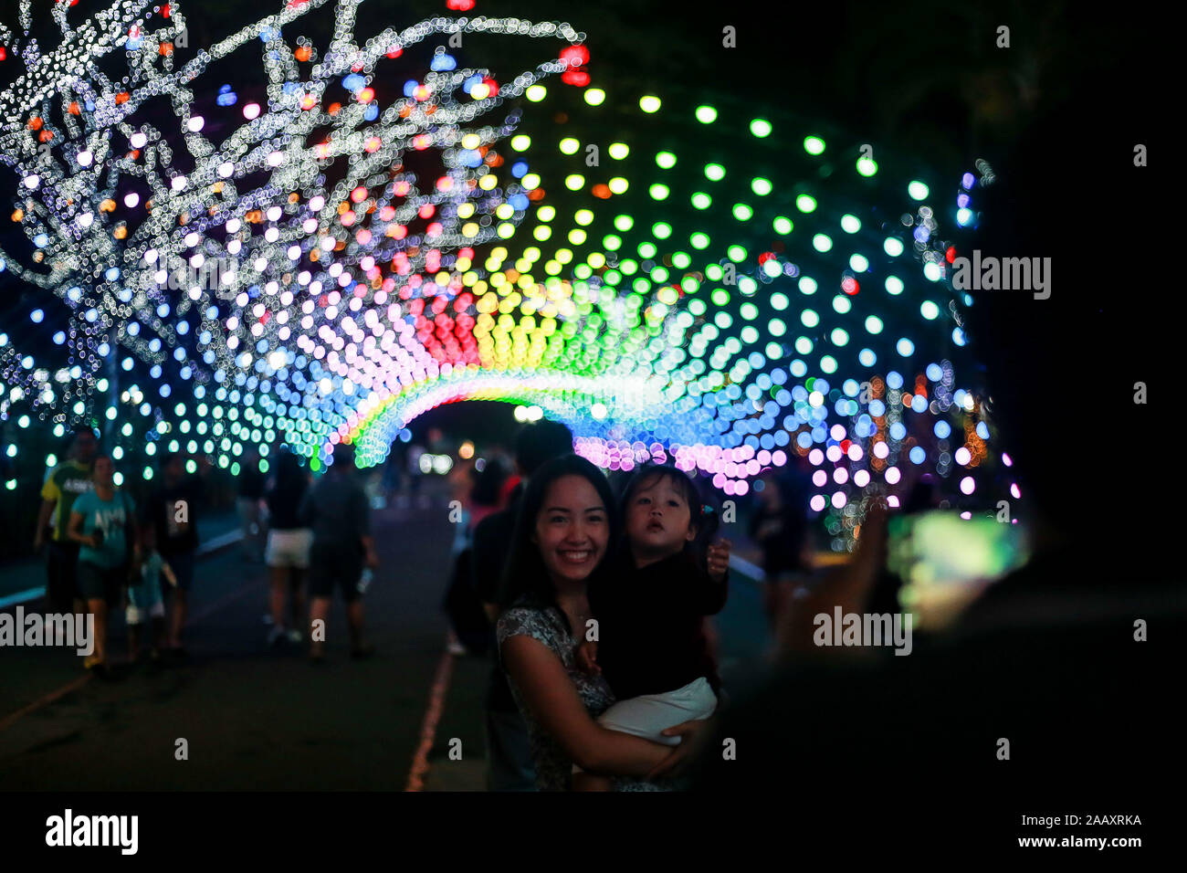 Quezon City. 24th Nov, 2019. Visitors pose for photos with colorful