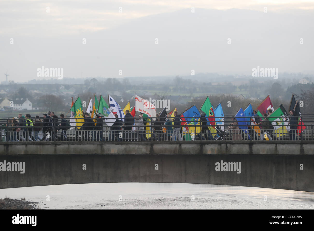 People take part in an Irish unity march as they cross the Lifford Bridge, from Donegal, which marks the border between Strabane in County Tyrone, Northern Ireland, and Lifford in County Donegal in the Republic of Ireland. Stock Photo