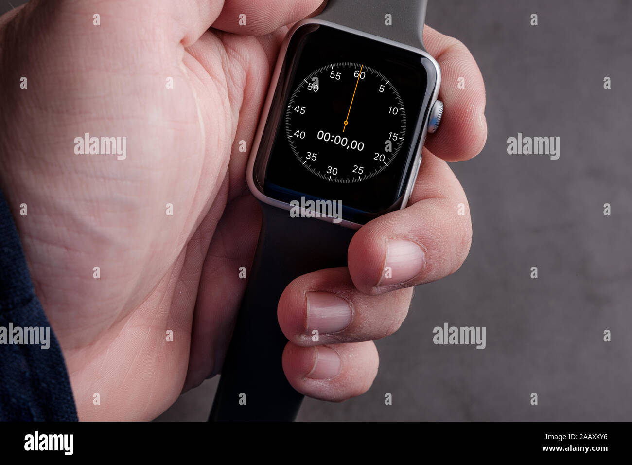 Man holding smart watch  with the chronometer on the screen Stock Photo