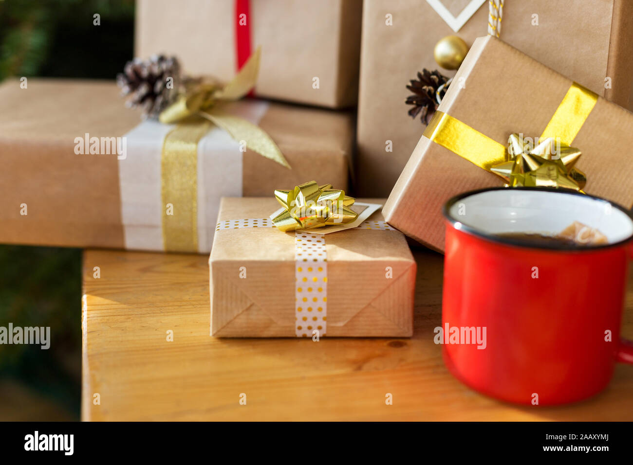 Gift boxes with cup of tea on wooden table. Concept of holiday picture Stock Photo