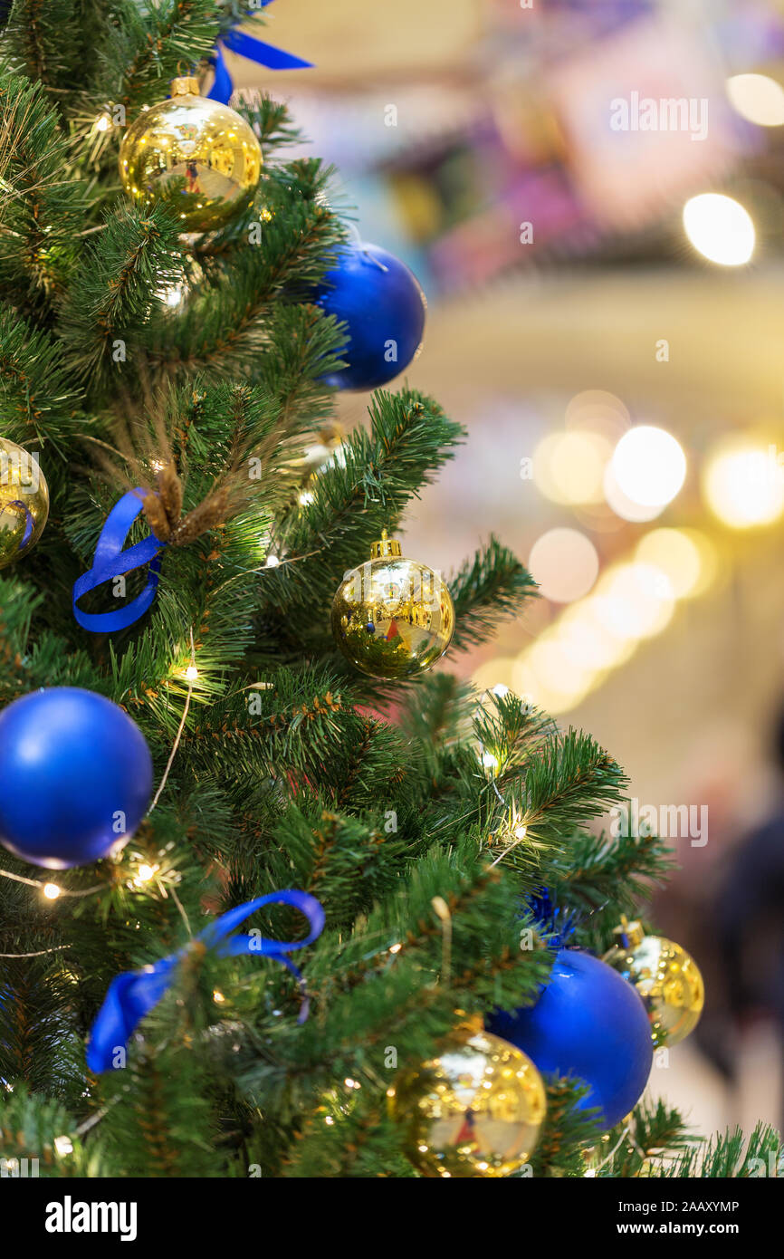 Close up Christmas tree with lights and blue and golden Christmas toys Stock Photo