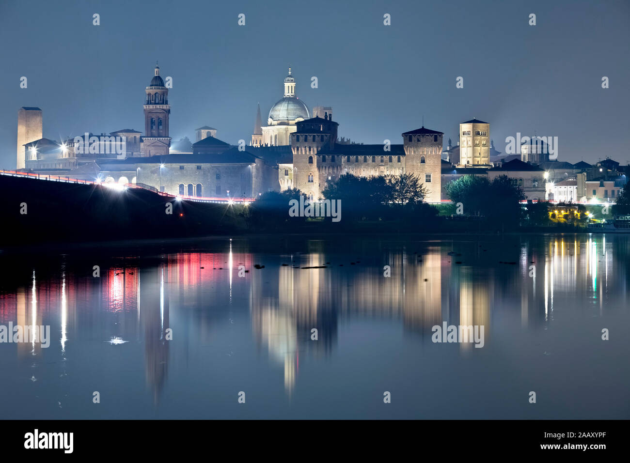 Mantova is reflected on the middle lake of the Mincio river. The city is one of the main centers of the Italian and European Renaissance. Italy. Stock Photo
