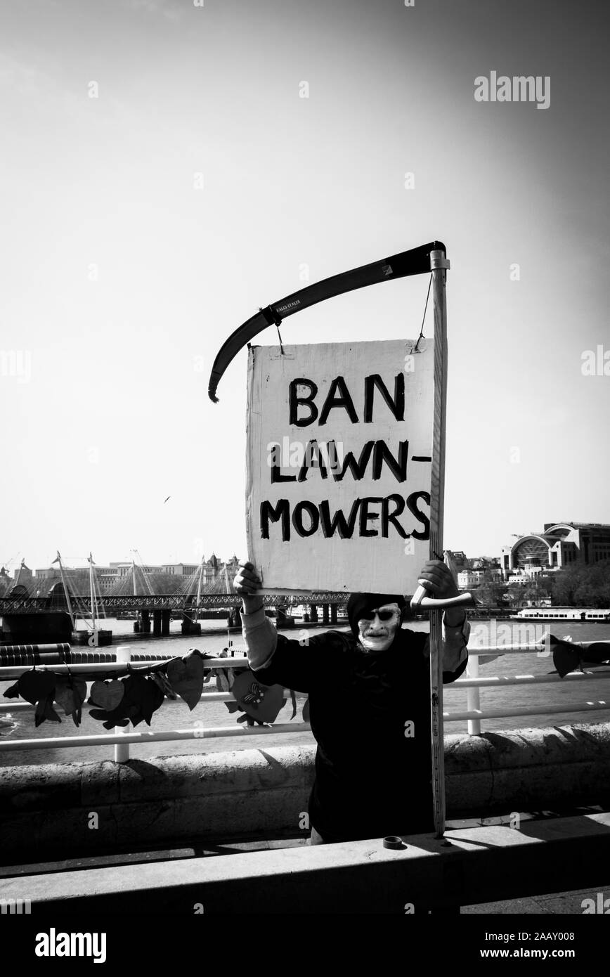 Ban Lawn Mowers - Humorous protester at climate protests Waterloo Bridge, London April 2019 Stock Photo