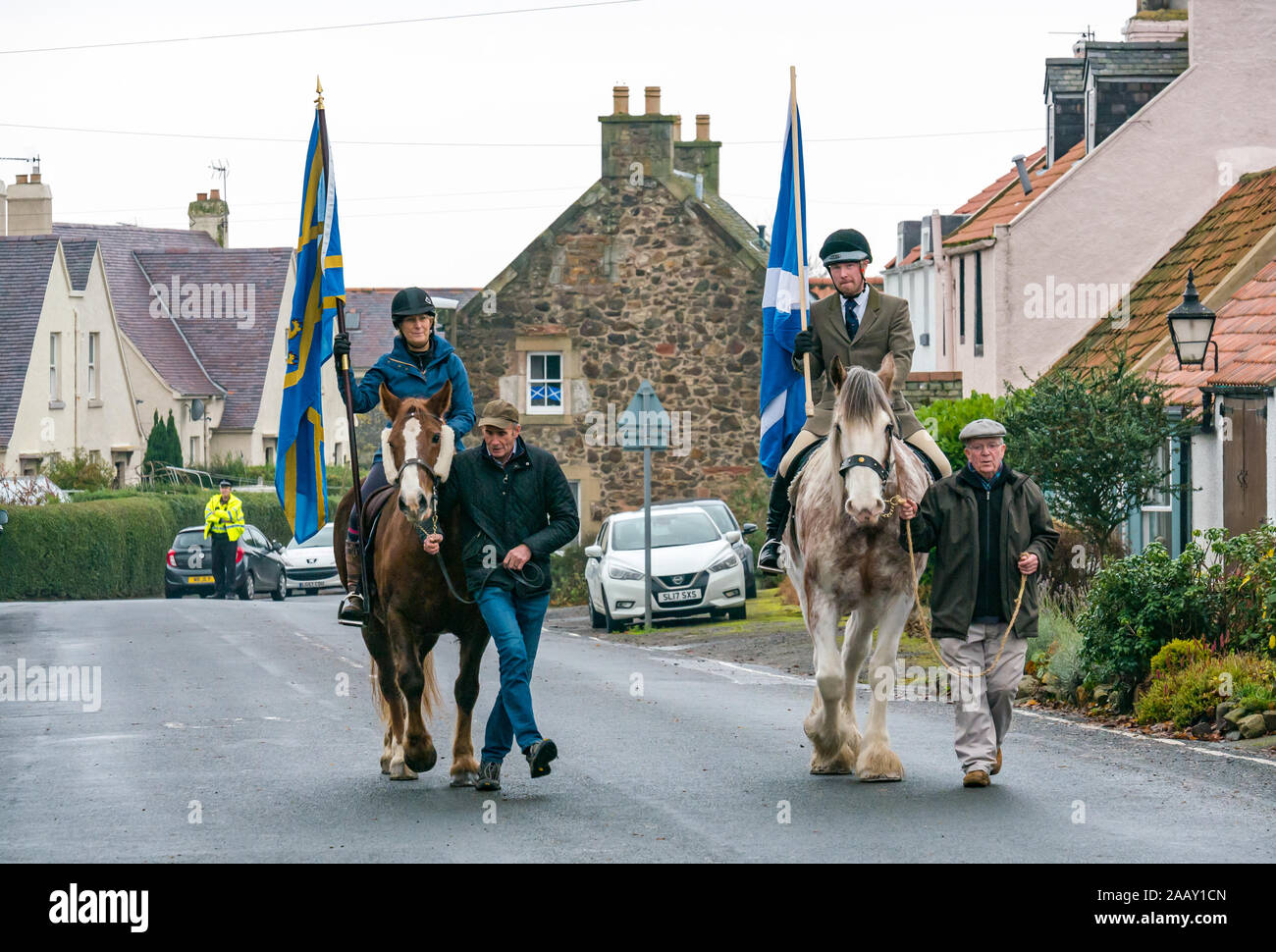 Athelstaneford, East Lothian, Scotland, UK. 24 November 2019. Saltire Festival: The first day of the annual festival to mark St Andrew’s Day takes place in the birthplace of the Scottish national flag where the saltire appeared in the sky as a good omen when the Picts & Scots defeated the Saxons led by Athelstan. Catherine Campbell on chestnut Irish Draft/Welsh Cob mare with groom Robert Campbell & Craig Donnelly on Strawberry Roan Clydesdale mare with groom/owner Arthur Greenan Stock Photo